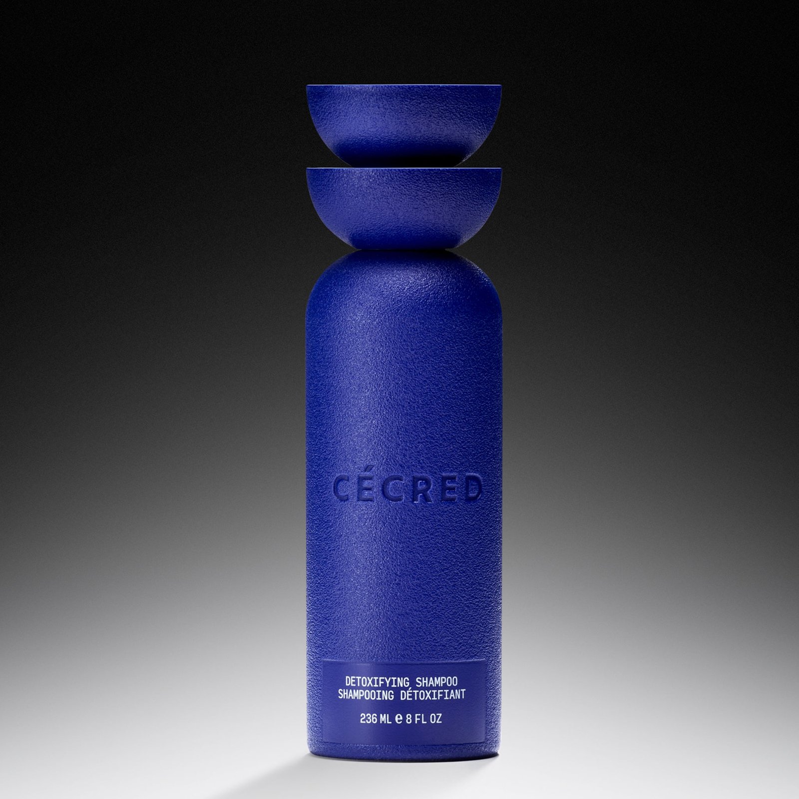 Cécred Detoxifying Shampoo in blue bottle with 'Cécred' branding on a gradient background