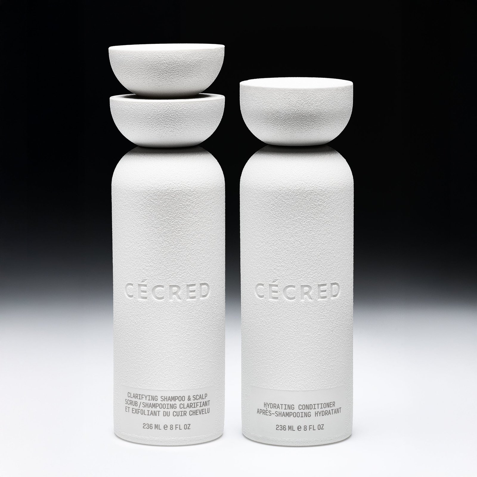 Cécred Double Cleanse Duo Kit — two white cylindrical bottles with matching bowl-shaped caps