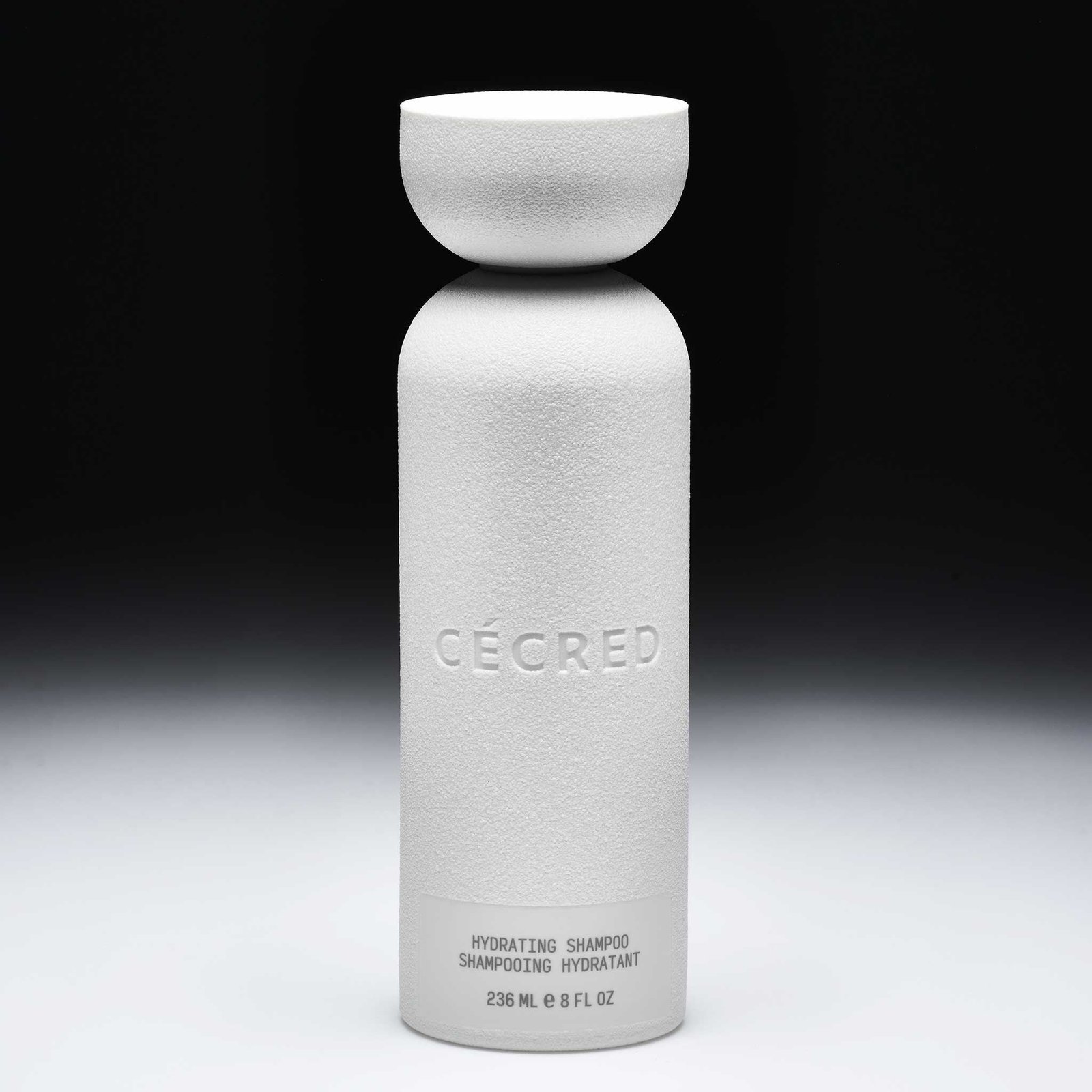 Cécred Hydrating Shampoo bottle displayed upright on a gradient black-to-white background