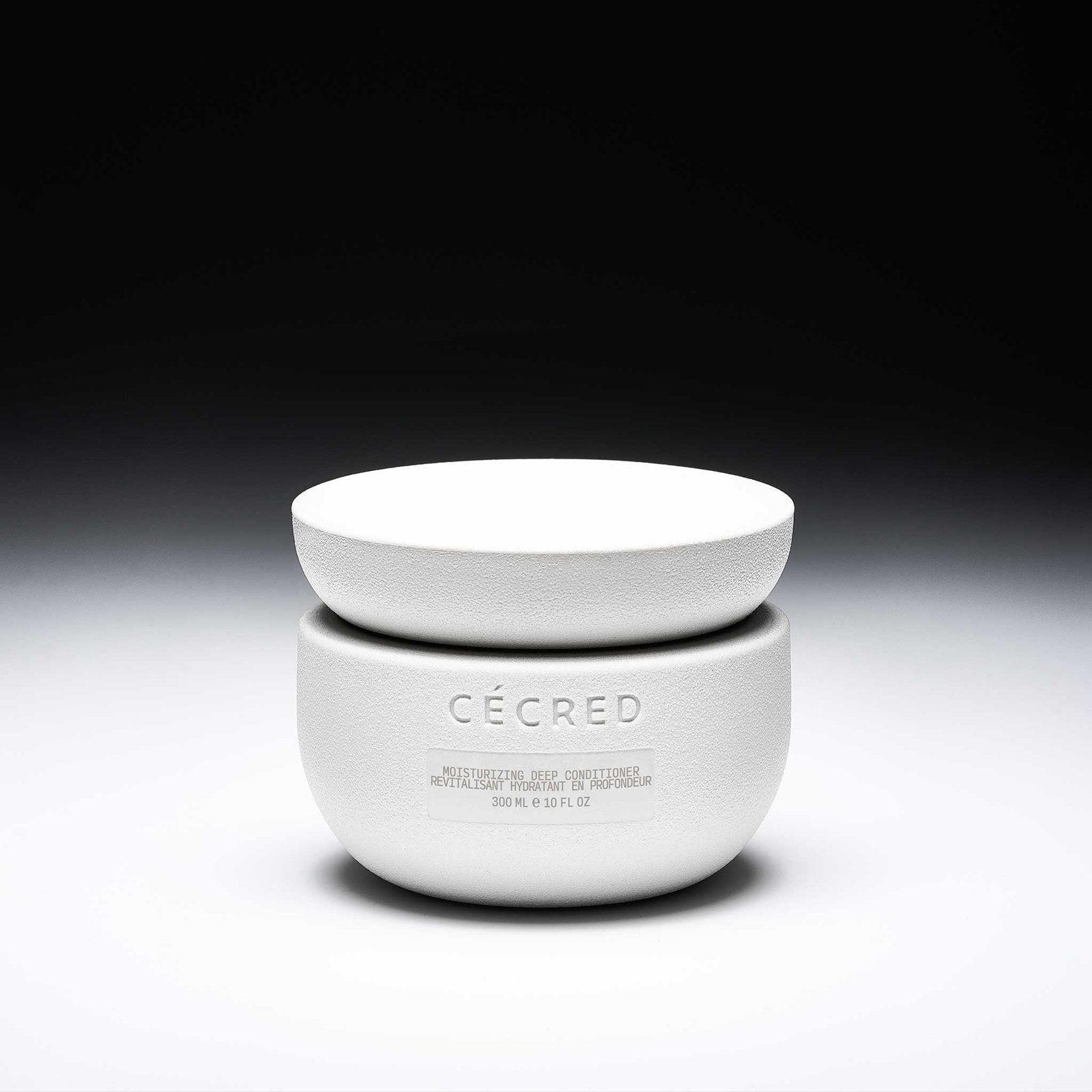 Cécred Moisturizing Deep Conditioner 10 fl oz sculpted jar displayed against a gradient black-to-white background