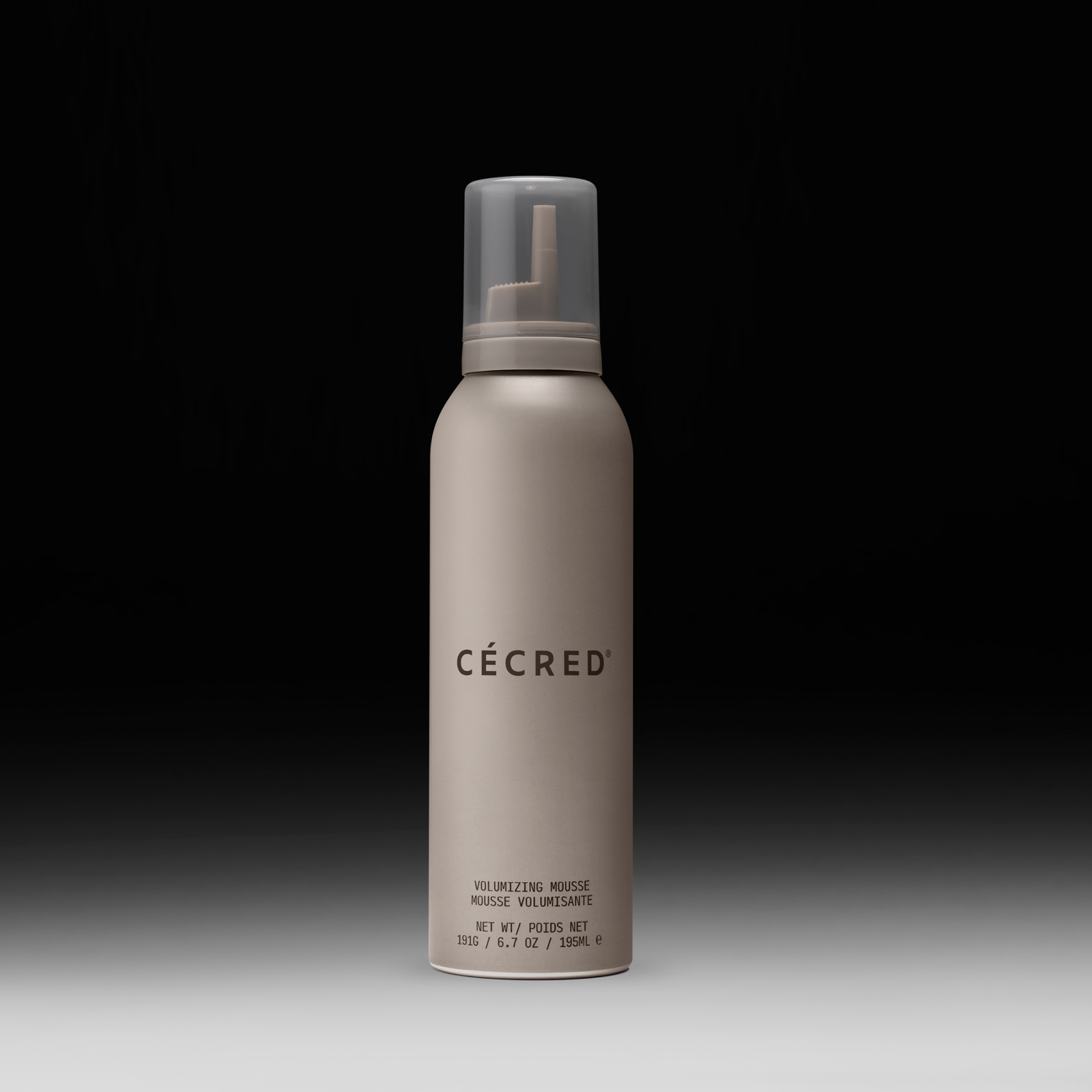 Cécred Volumizing Mousse bottle displayed upright on a gradient black-to-white background